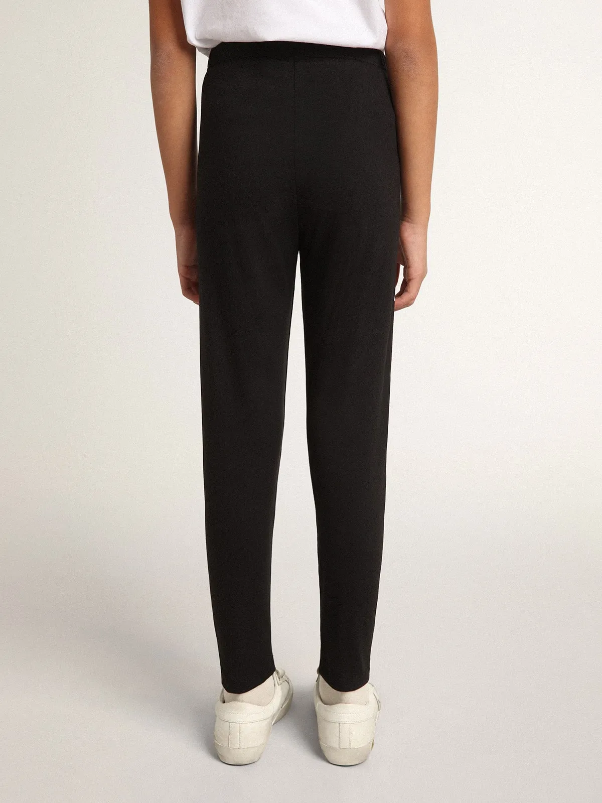 Pantalón leggings de color negro de niña con estrellas blancas en los lados